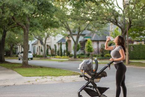 Woman running pushing a baby in stroller 